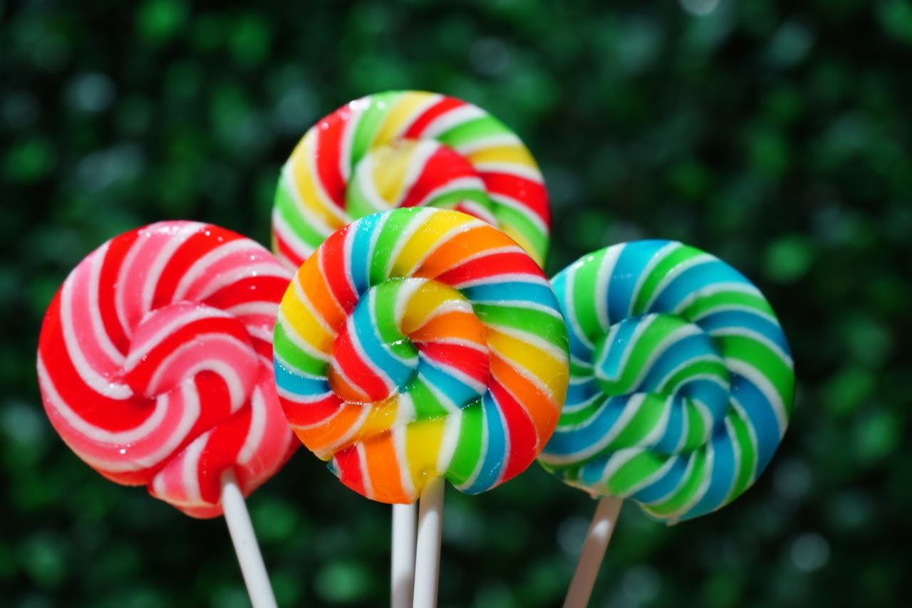 service-03 colorful-swirl-lollipops-against-green-background-34191896