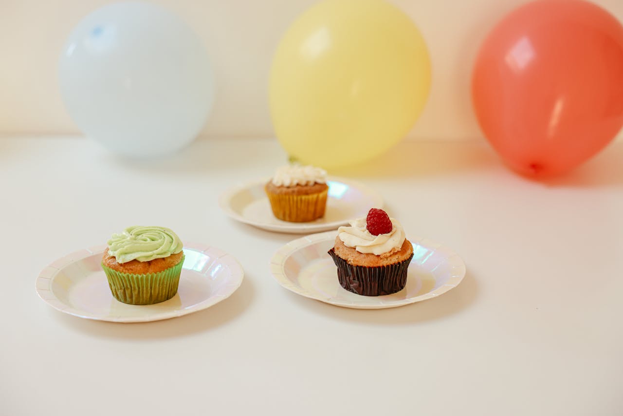 our-vission Delicious cupcakes with colorful balloons create a festive celebration atmosphere.