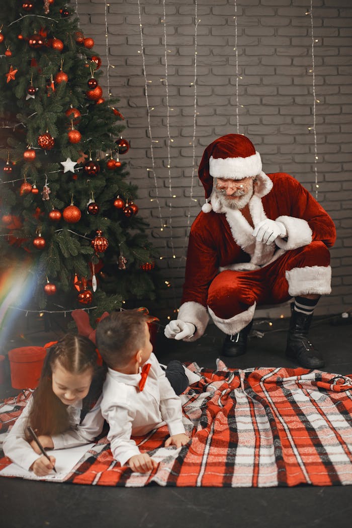 engagement-photography-03 Children with Santa Claus by a Christmas tree enjoying holiday festivities indoors.